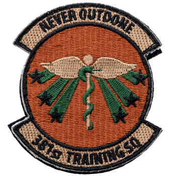 Embroidered 381st Training SQ patch with a central caduceus, green star rays, and an orange background.