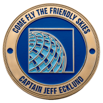 Gold and blue challenge coin featuring the United Airlines globe logo, captioned 'Come Fly The Friendly Skies' and 'Captain Jeff Ecklund'.