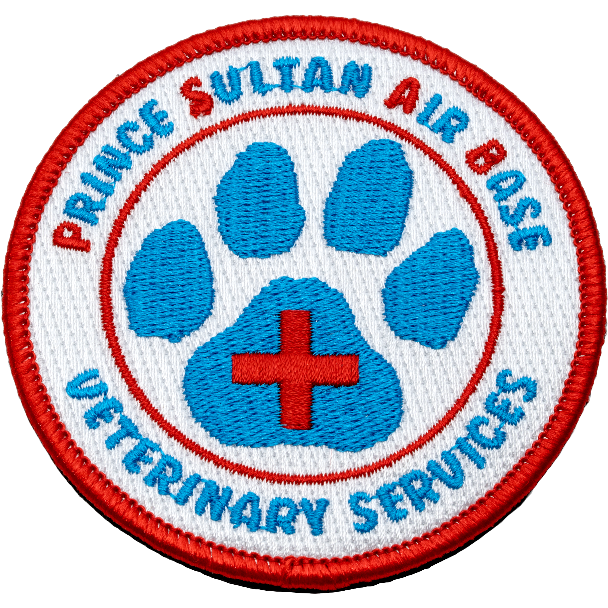 Embroidered round patch for Prince Sultan Air Base Veterinary Services featuring a blue paw print with a red cross on a white background and red border.