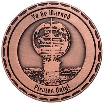Antique copper challenge coin featuring a silhouette of a pirate ship against a large moon with text reading Ye be Warned Pirates Only.