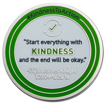 Round silver challenge coin with green enamel rings featuring the hashtag KindnessToAction and a quote by Elijah James Knight.