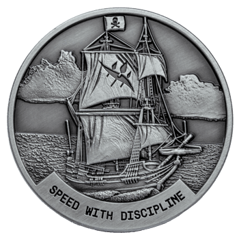 Antiqued silver coin featuring a pirate ship with a skull and crossbones flag and the text Speed With Discipline.