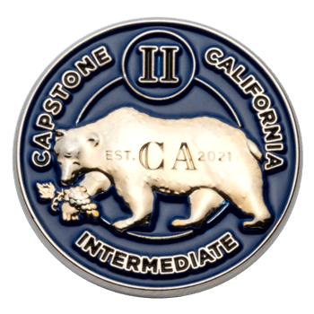 A circular blue and silver challenge coin featuring a California grizzly bear, grapes, and the text Capstone II California Intermediate.