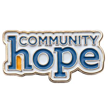 Enamel lapel pin featuring the text Community Hope in blue lettering with a gold border on a white background.