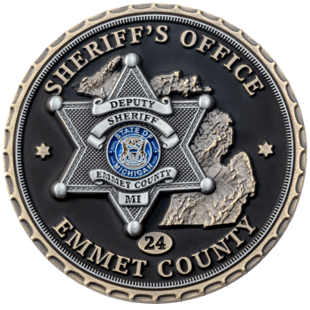 Circular challenge coin for Emmet County Sheriff's Office featuring a six-pointed star badge, State of Michigan seal, and 3D map of Michigan on a black backgrou