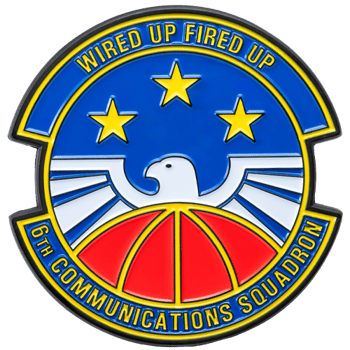 Circular military challenge coin for the 6th Communications Squadron featuring an eagle, three gold stars, and a red dome on a blue background.