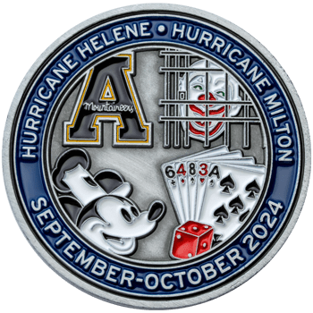 Antique silver challenge coin featuring a block A logo, a clown behind bars, Mickey Mouse, playing cards, and a red die with a blue enamel border.