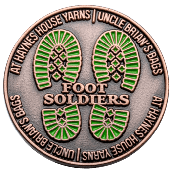 Antique copper challenge coin featuring green boot print icons and the text Foot Soldiers, Haynes House Yarns, and Uncle Brian's Bags.