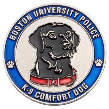 Circular silver and blue challenge coin featuring a black dog with a red collar, captioned Boston University Police K-9 Comfort Dog.