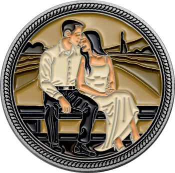 Round challenge coin featuring an enameled illustration of a couple sitting together on a bench against a scenic sunset backdrop.