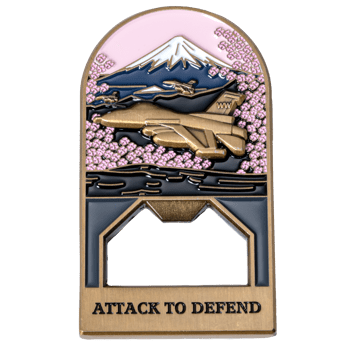Arched metal bottle opener featuring a fighter jet flying past Mount Fuji and cherry blossoms with the text Attack to Defend.